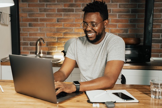 Man Smiling at Laptop
