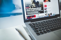 grey laptop open to searching real versus fake news